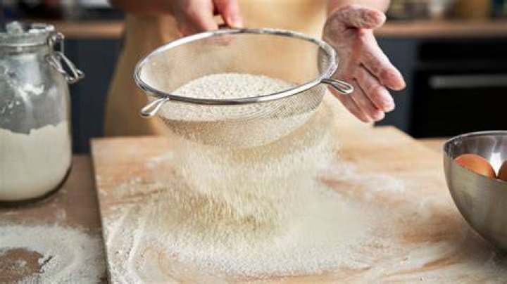 How do you remove dried flour from sifters?
